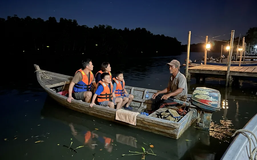 A small wooden boat on the Selangor river at night waiting for fireflies