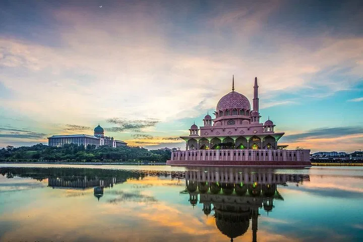 The rose-tinted Putra Mosque and Perdana Putra across Putrajaya Lake at sunset